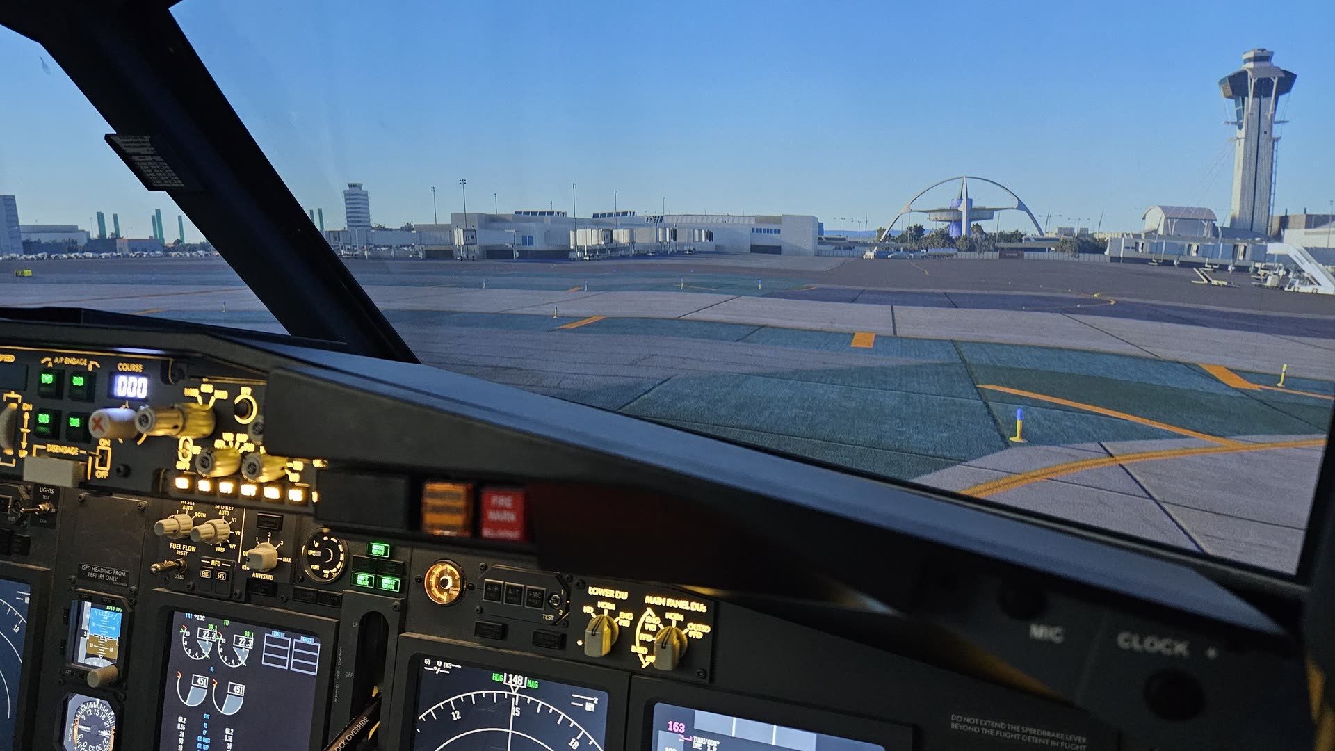 Captain's view of Los Angeles International: the iconic LAX Theme Building through the windshield