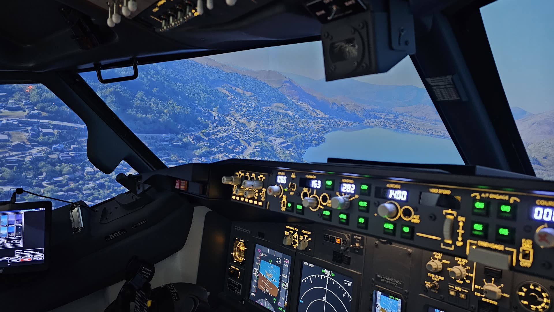 MCP glare shield with approach scenery on screen